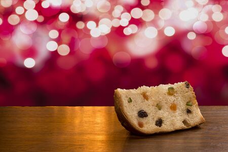 Brazilian panettone, a traditional pastry in Brazilian Christmas with a red lights background.の写真素材