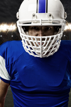 Close up of a Football Player with a blue uniform on a stadium.の写真素材