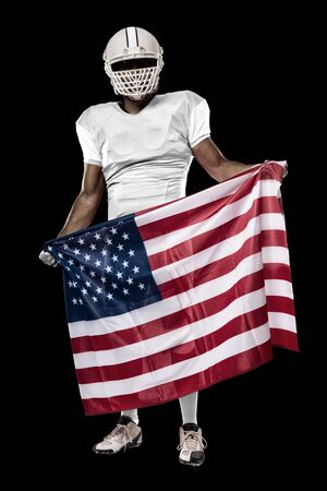 Football Player with a white uniform and a american flag, on a black background.の写真素材