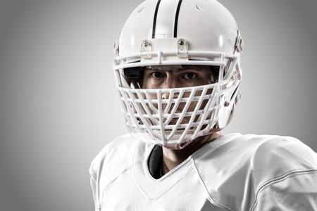 Close up of a Football Player with a white uniform on a white background.の写真素材