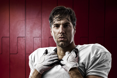 Football Player with a white uniform on a Locker roon.