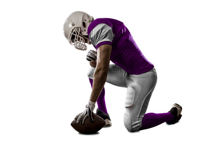 Football Player with a pink uniform on his knees, on a white background.の写真素材