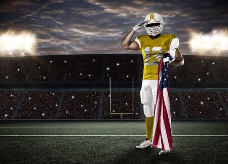 Football Player with a yellow uniform saluting with a american flag, on Stadium.