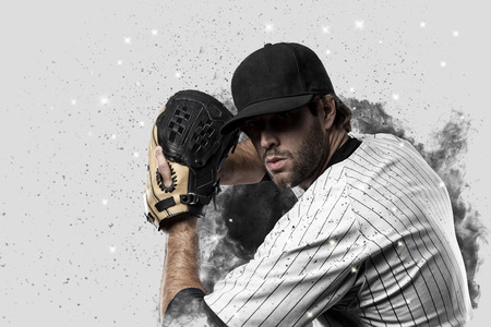 Baseball Player with a white uniform coming out of a blast of smoke .の写真素材