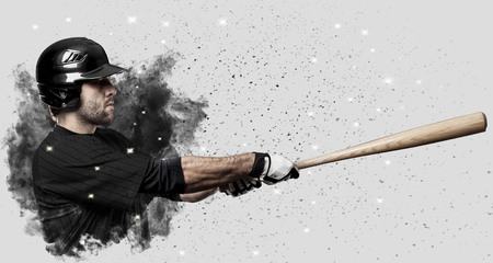 Baseball Player with a black uniform coming out of a blast of smoke .の写真素材
