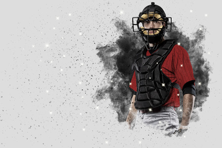 Catcher Player with a red uniform coming out of a blast of smoke .の写真素材