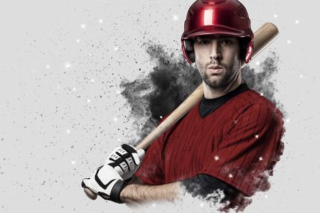 Baseball Player with a red uniform coming out of a blast of smoke .の写真素材