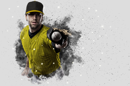 Baseball Player with a yellow uniform coming out of a blast of smoke .の写真素材