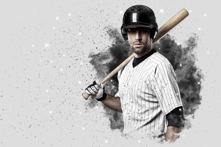 Baseball Player with a white uniform coming out of a blast of smoke .