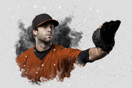 Baseball Player with a orange uniform coming out of a blast of smoke .の写真素材