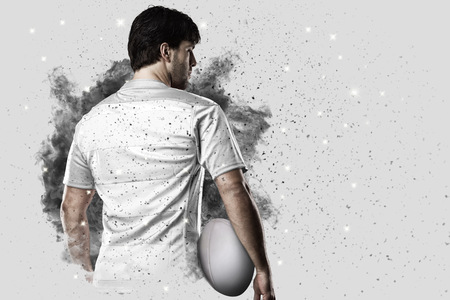 Rugby Player with a white uniform coming out of a blast of smoke .の写真素材