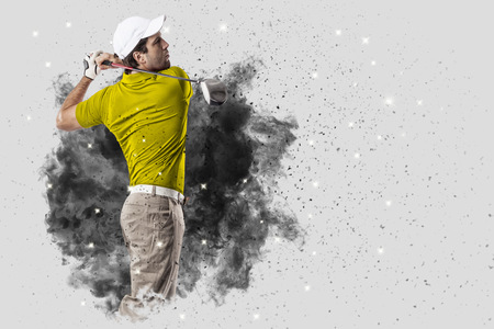 Golf Player with a yellow uniform coming out of a blast of smoke .の写真素材