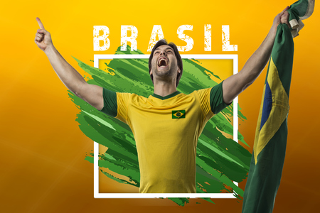 Brazilian soccer player, celebrating on a yellow background with copy space.の写真素材