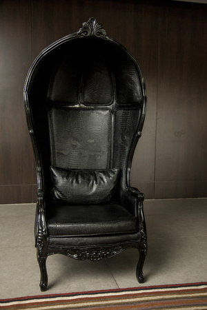 Black genuine leather classical style sofa in vintage room