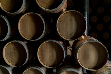 Porto Wine barrels stacked in the old cellar of the winery.