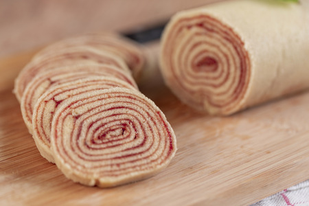 Bolo de rolo (swiss roll, roll cake) typical Brazilian dessert, from the state of Pernambuco. Sliced cake roll filled with Guava paste.の写真素材