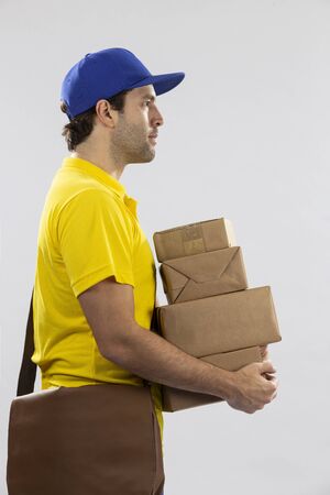 Brazilian mailman on a white background delivering a package. copy space.