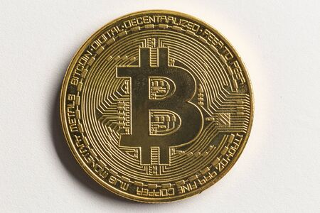 physical bitcoin on a white background