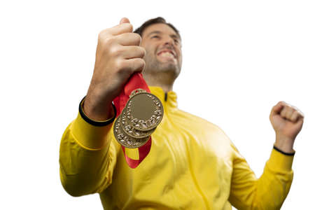 male athlete smiling after winning a gold medal in a white background. Sportsman with medal celebrating his victory.の写真素材
