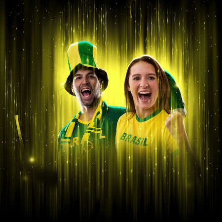 Brazilian couple Celebrating the cup on a black background with yellow glow, cheering for Brazil to be the champion.の写真素材