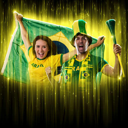 Brazilian couple Celebrating the cup on a black background with yellow glow, cheering for Brazil to be the champion.の写真素材
