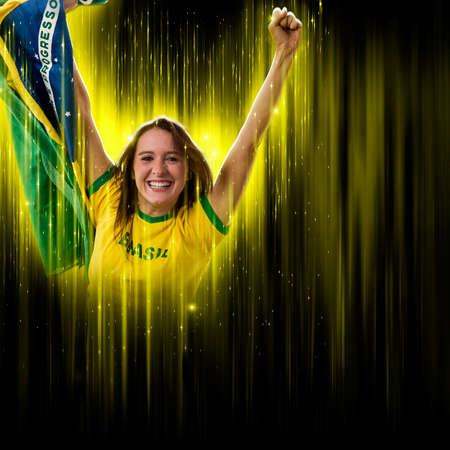 Brazilian woman fan, celebrating on a yellow and black backgroun, cheering for Brazil to be the champion.の写真素材
