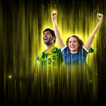 Brazilian couple Celebrating the cup on a black background with yellow glow, cheering for Brazil to be the champion.の写真素材