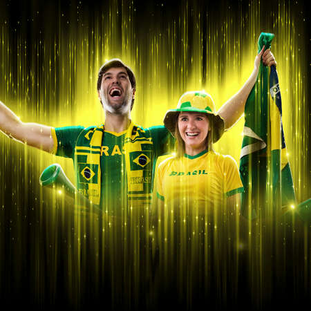 Brazilian couple Celebrating the cup on a black background with yellow glow, cheering for Brazil to be the champion.の写真素材