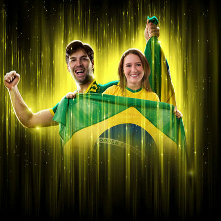 Brazilian couple Celebrating the cup on a black background with yellow glow, cheering for Brazil to be the champion.の写真素材