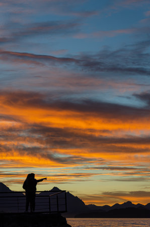 Silhouette of a photographer at sunset in the Lofoten islands, Norwayの写真素材