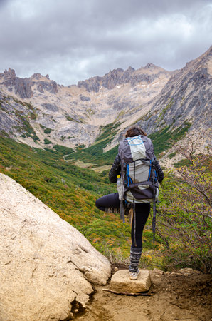 Hiking in the mountains. A woman with a backpack on the trail.の写真素材