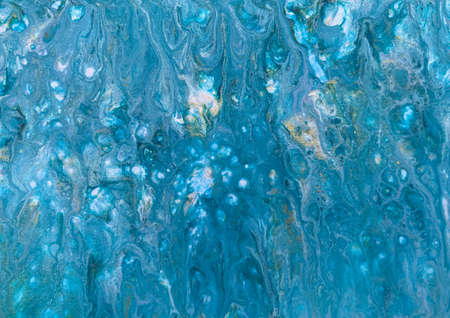 A photograph of an acrylic fluid art painting. Features blue and silver paint to give the effect of water shimmering in the summer sun.の写真素材