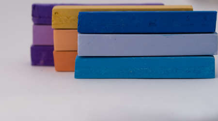 Square colorful pastel chalks tops close up, on white backgroundの写真素材