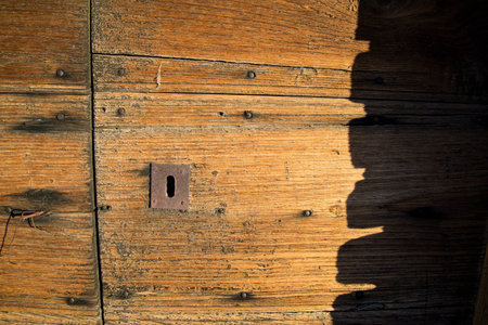 Ancient wooden door in old stone wall,front viewの写真素材
