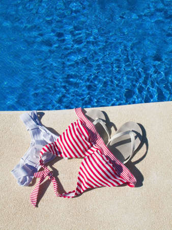 femal swimsuit left at pool edgeの写真素材
