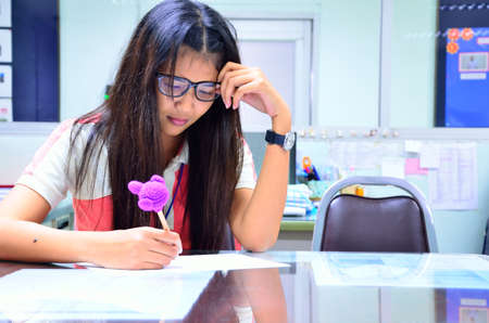 Woman is thinking a job in officeの写真素材