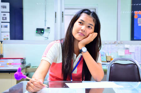 Woman is thinking an idea in officeの写真素材