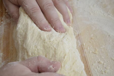 The cook kneads the dough.の写真素材