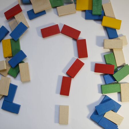 Colored dominoes are scattered. Question mark of colored dominoes, on a white background. Colorful...
