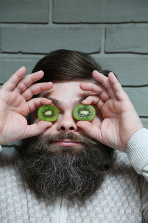 A bearded man with a kiwi in his eyesの写真素材