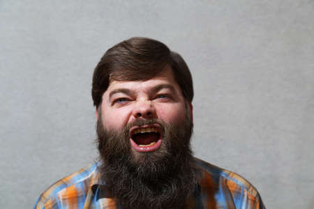Portrait. A man with a long beard and an open mouth.