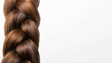 A braid of hair on a white background. Top view. Close-up. Hair style. Hair. Hair care.