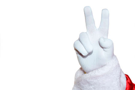A hand in a white glove, two fingers raised up on a white background. Santa Claus shows a positive gesture. Isolate.の写真素材