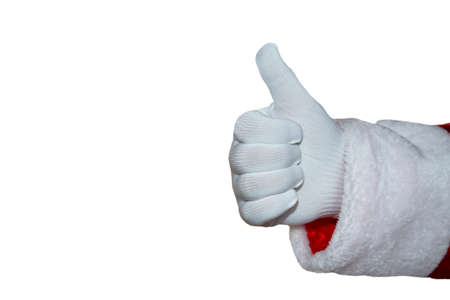 A hand in a Santa Claus glove on a white background. Holiday, positive. Thumbs up, hand gesture. New Year, Christmas, Isolate.の写真素材