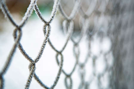 Metal fence. Background. There is snow on the fence.の写真素材