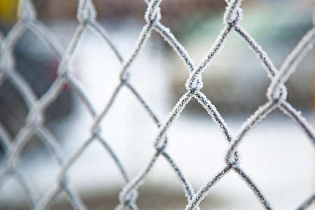 Metal fence in winter. Frost on the fence. Close-up. Winter time, frosts.の写真素材