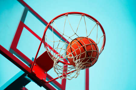 A basketball in the net. The fly ball is in the ring. A sports game. Conceptual: victory, success,...