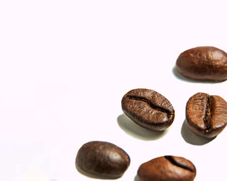 Roasted coffee beans on a white background. Isolate. Macro photography. Close-up.の写真素材