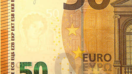 A fifty-euro bill illuminated by light. water signs. paper money. cash. finance. macro photo.の写真素材