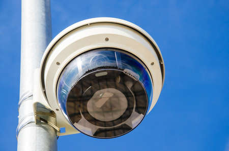 A recording device on the street. Video camera in the sky background. Surveillance camera in the city.の写真素材